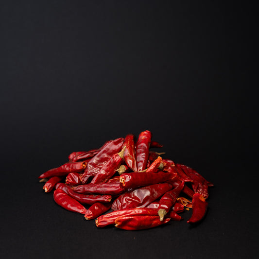 A pile of Chao Tian Jiao Chili pepper (Facing Heaven Pepper) on black background.