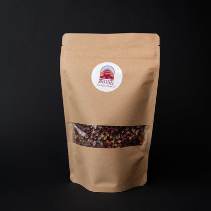 A package of red Sichuan peppercorns on a dark background. 
