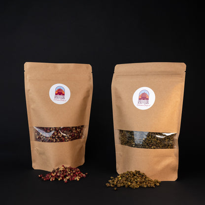 A package of red Sichuan peppercorn and green Sichuan peppercorn with a small pile of peppercorns in front of bag. 