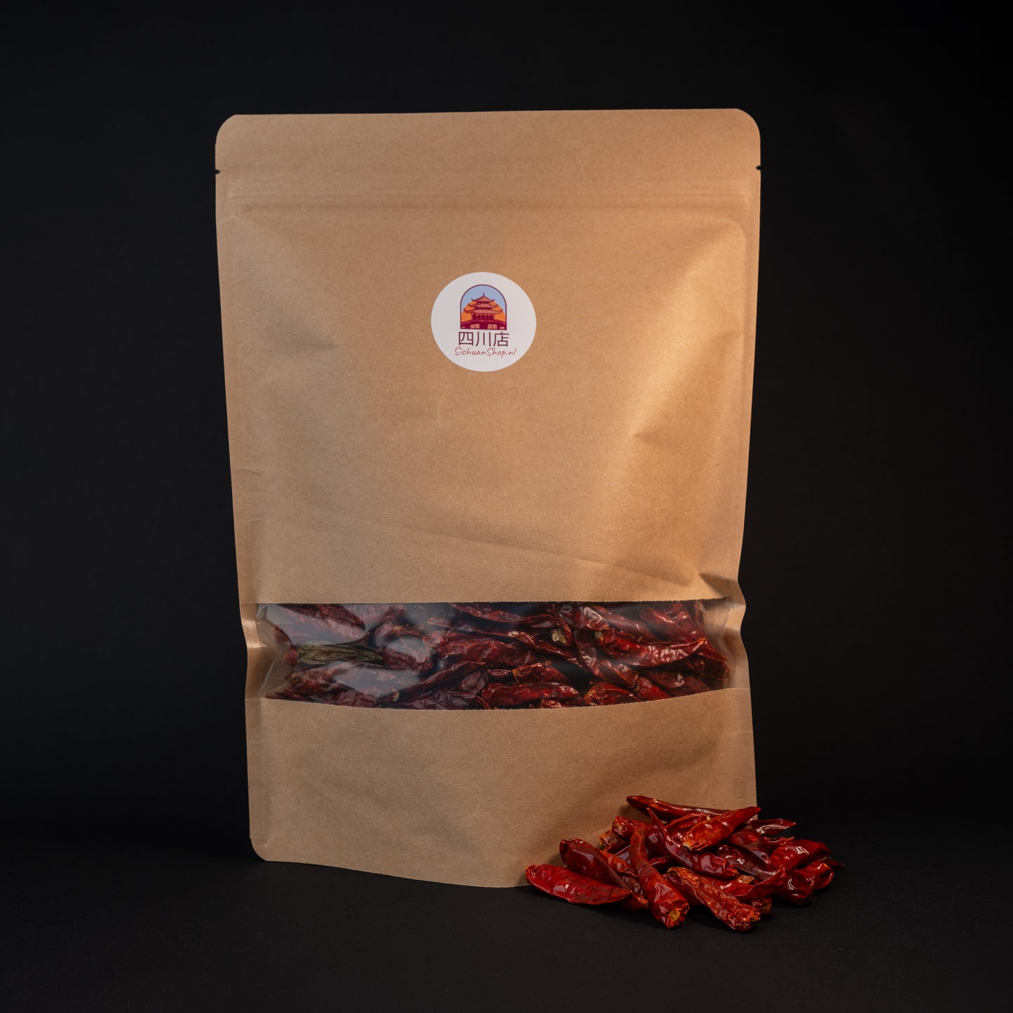 A package of xiao mi la chili peppers with a small pile of peppers in front. 
